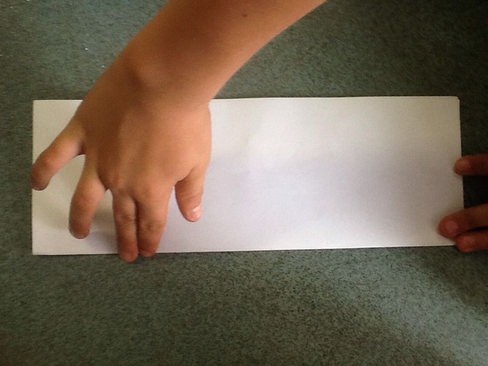 Fold paper in half along the length.