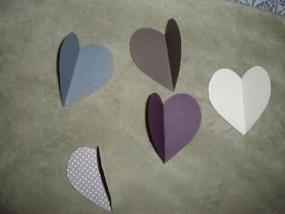 Fold paper in half and cut out desired shaped hearts (old school style).