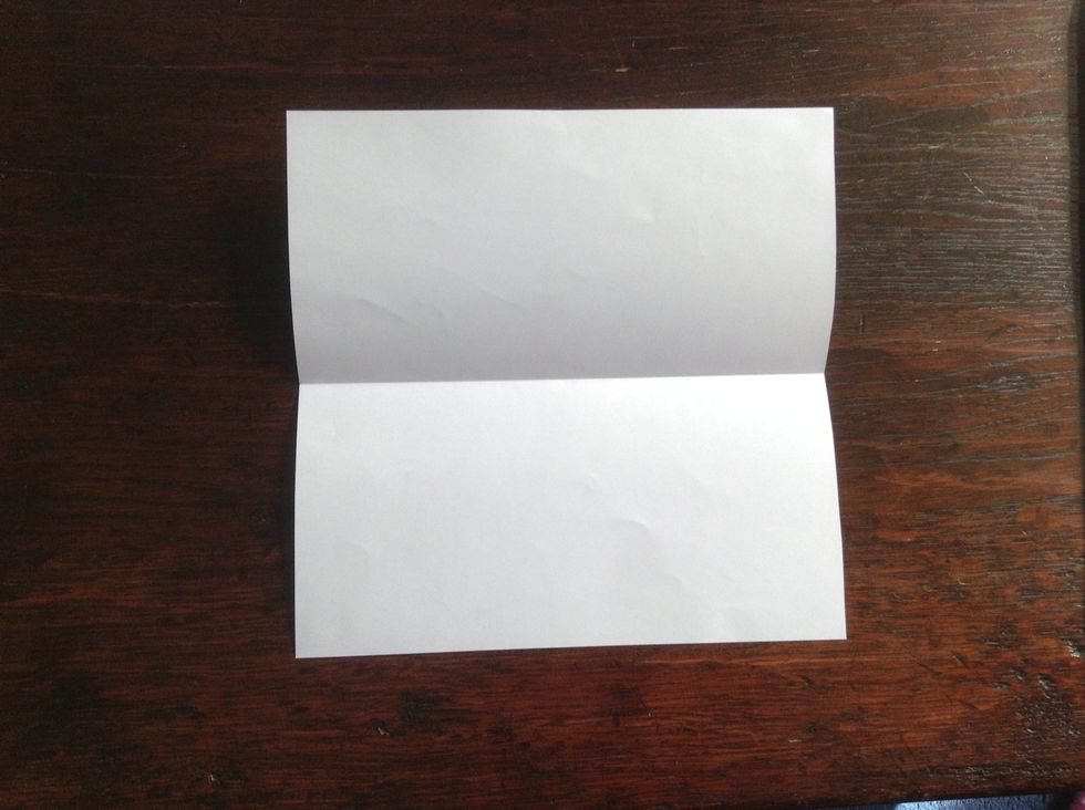 Fold paper in half and unfold to make a crease.