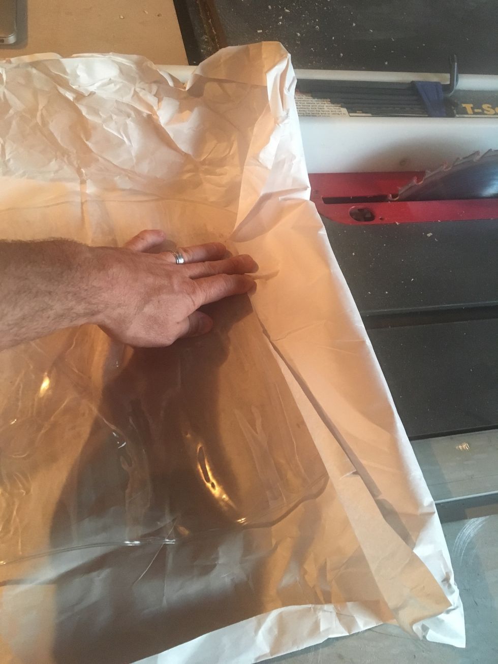 Fold paper over the closed end of the vacuum bag.