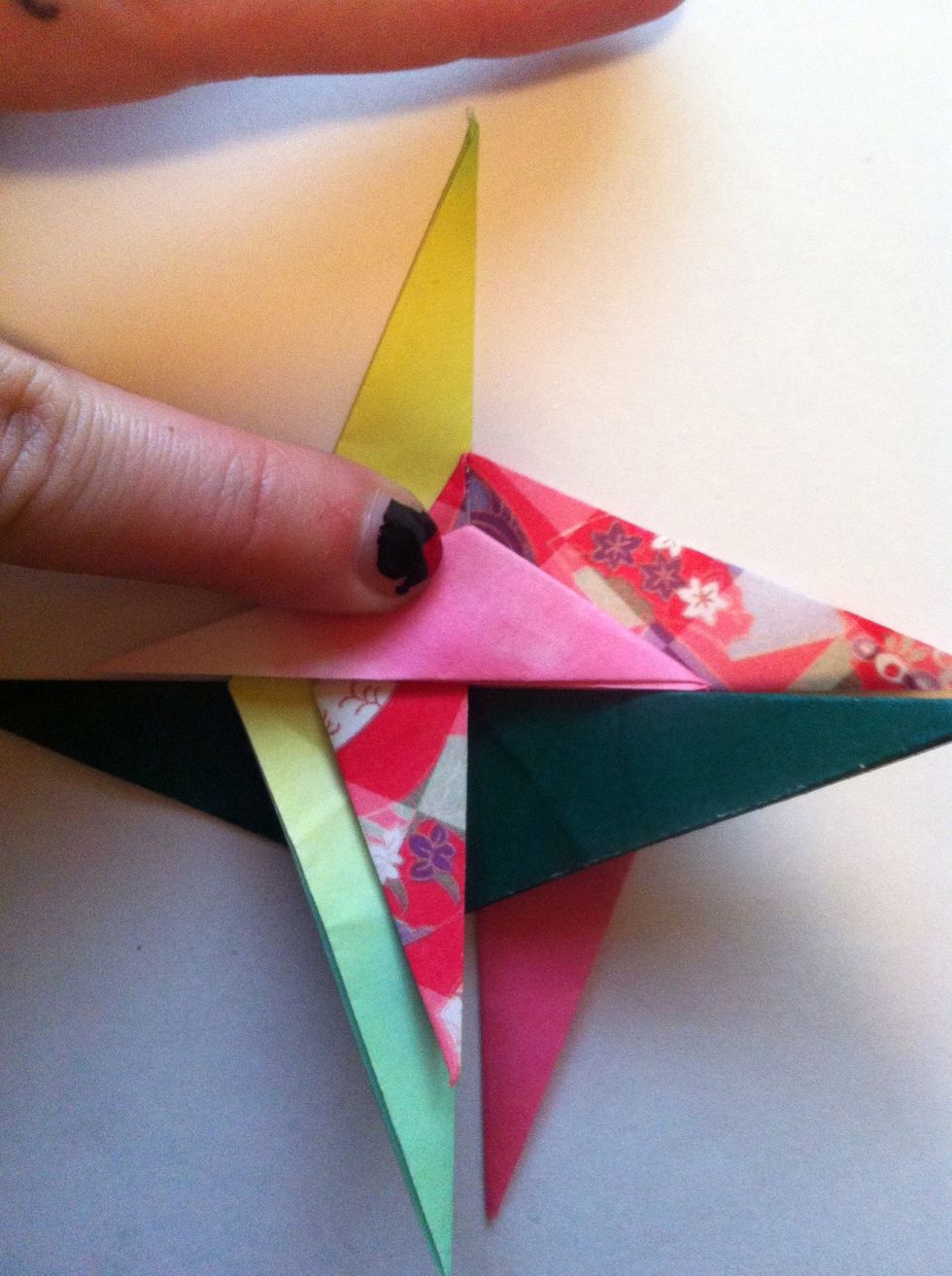 Fold pink one over towards left as shown.