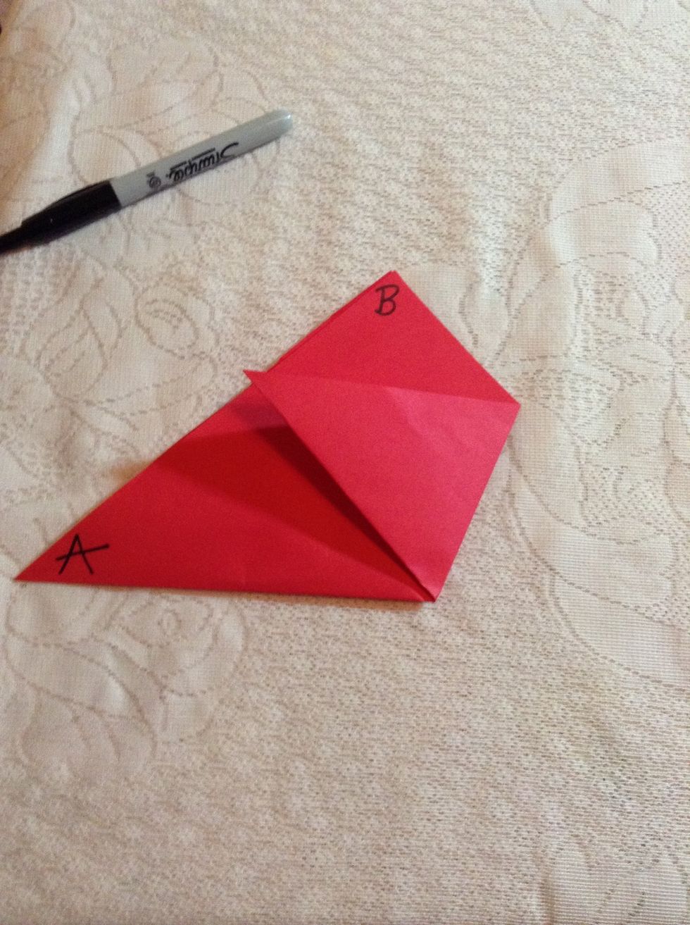 Fold point C to the edge of AB so that the top edge of the fold is parallel to the base of the original triangle. You should see three triangles.