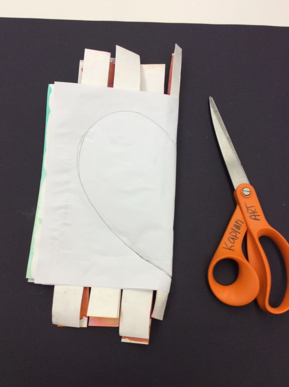 Fold project in half. Draw half of a large heart on one side of folded paper.