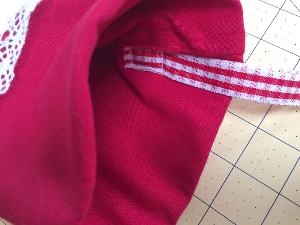 Fold ribbon in half and sew in position on the inside of stocking 5 inches down from top