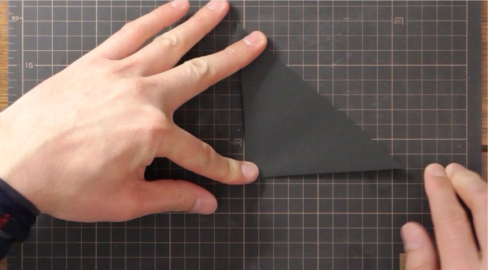 Fold right point to the left point and unfold.