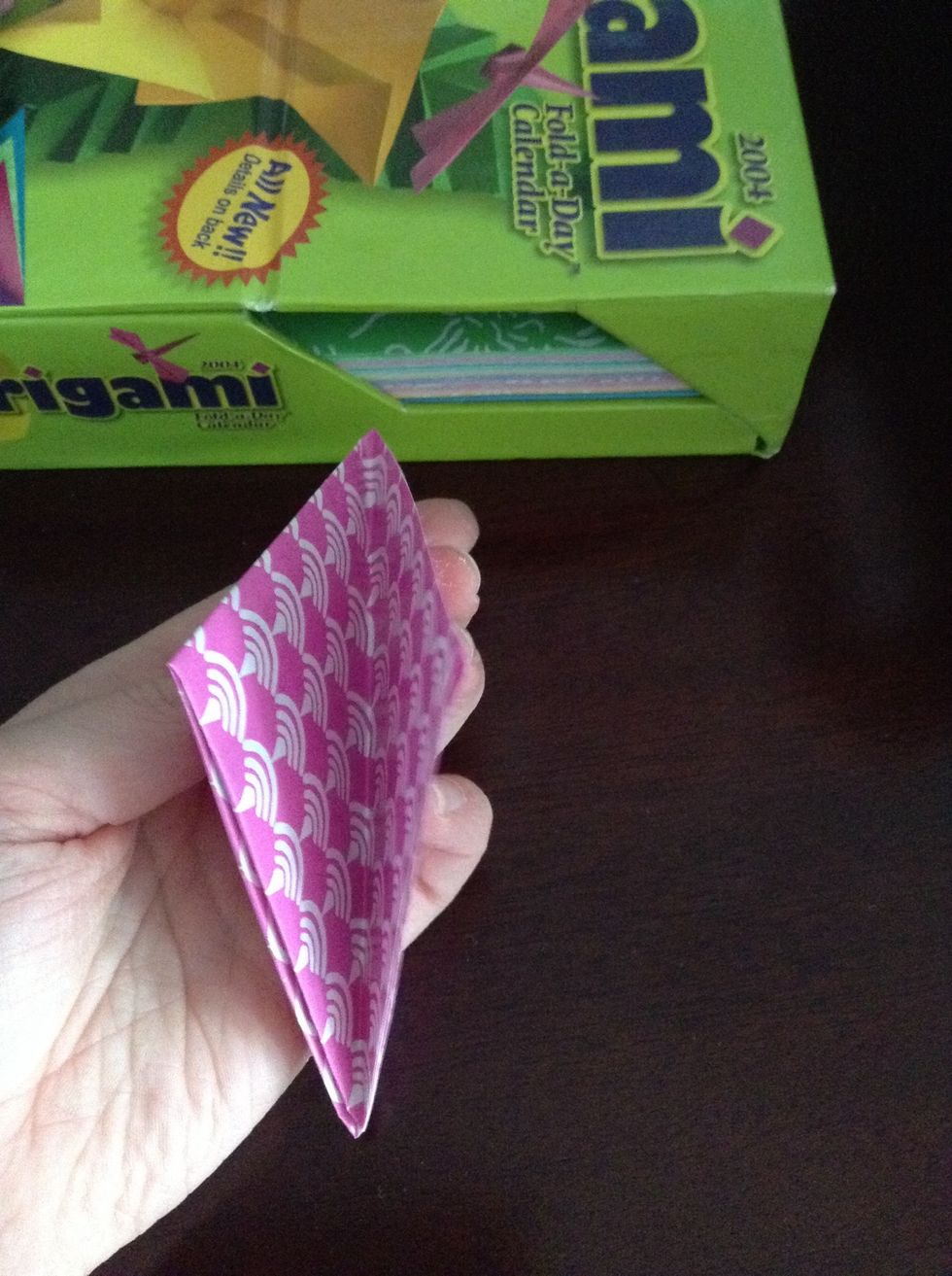 Fold so it's a triangle it should be open on this side these open sides are the ones you cut on