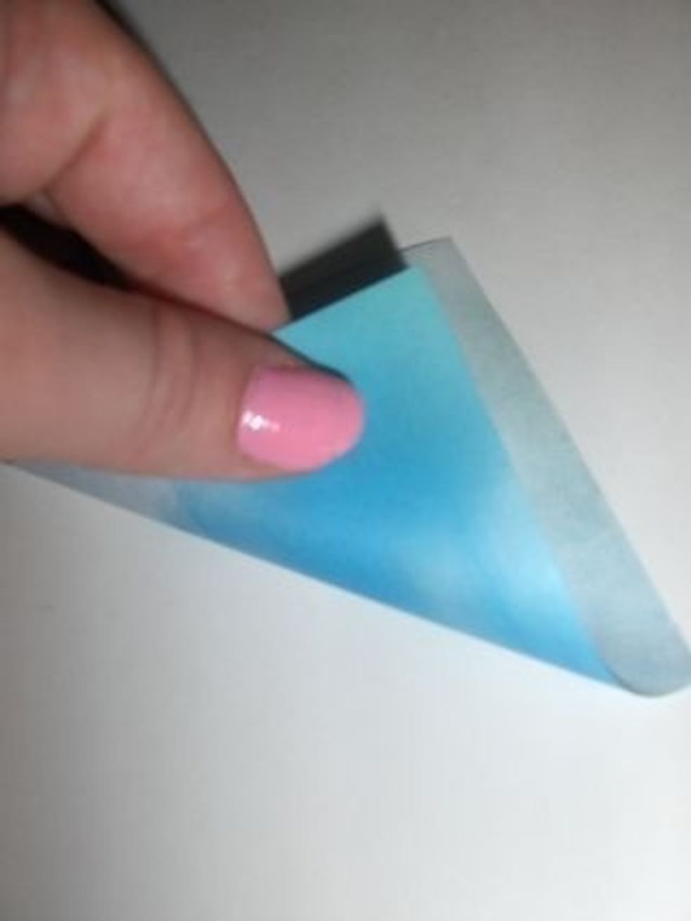 Fold square colored side down diagonally into a triangle.