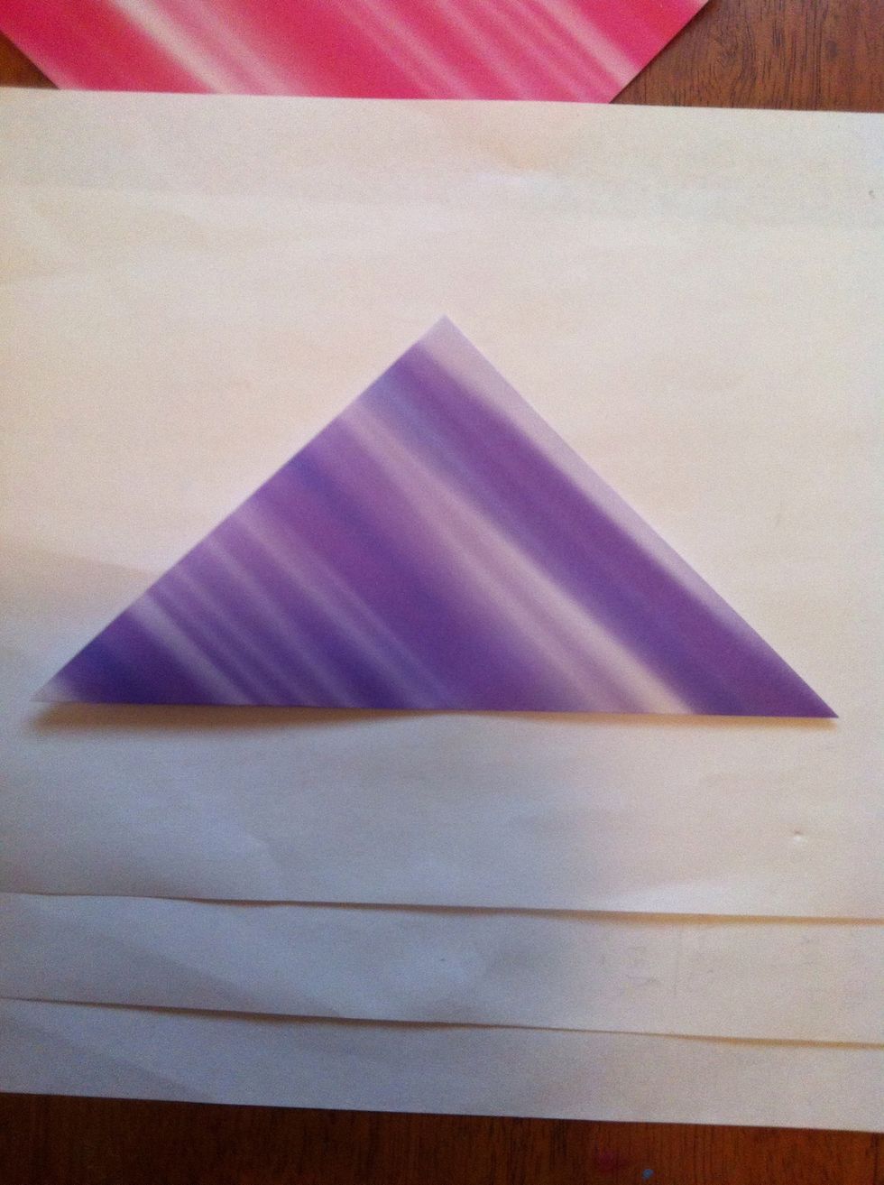 Fold square paper in half diagonally. My paper is 5-6 inches. I haven't tried smaller paper, but I would assume that with this design bigger is better.