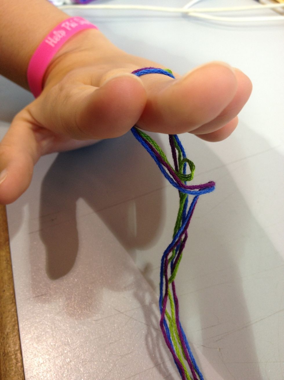 Fold strings in half, I normally loop around middle finger. We're tying the knot on top. This is how I do it, you can do it however you want