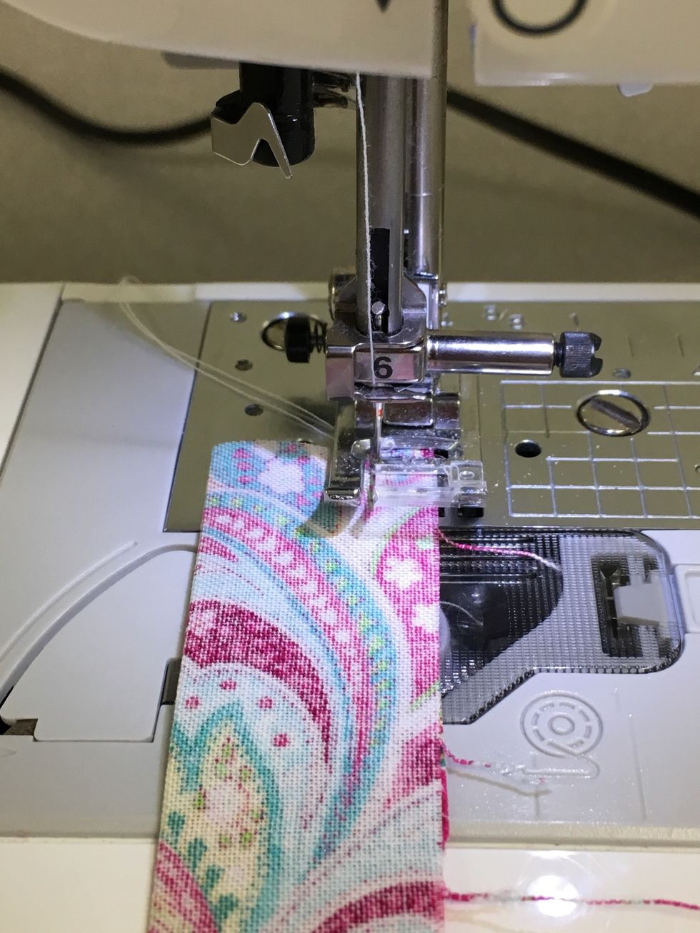 Fold the 2x5" rectangle in half lengthwise with right sides together. Press. Sew 1/4" seam along open side. Backstitch at each end.