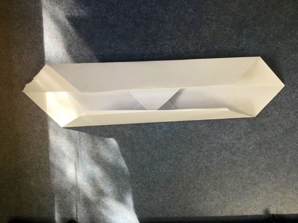 Fold the back of the corners to the centre as shown.