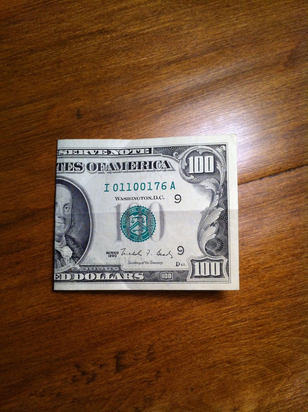 Fold the bill in half with the face out.