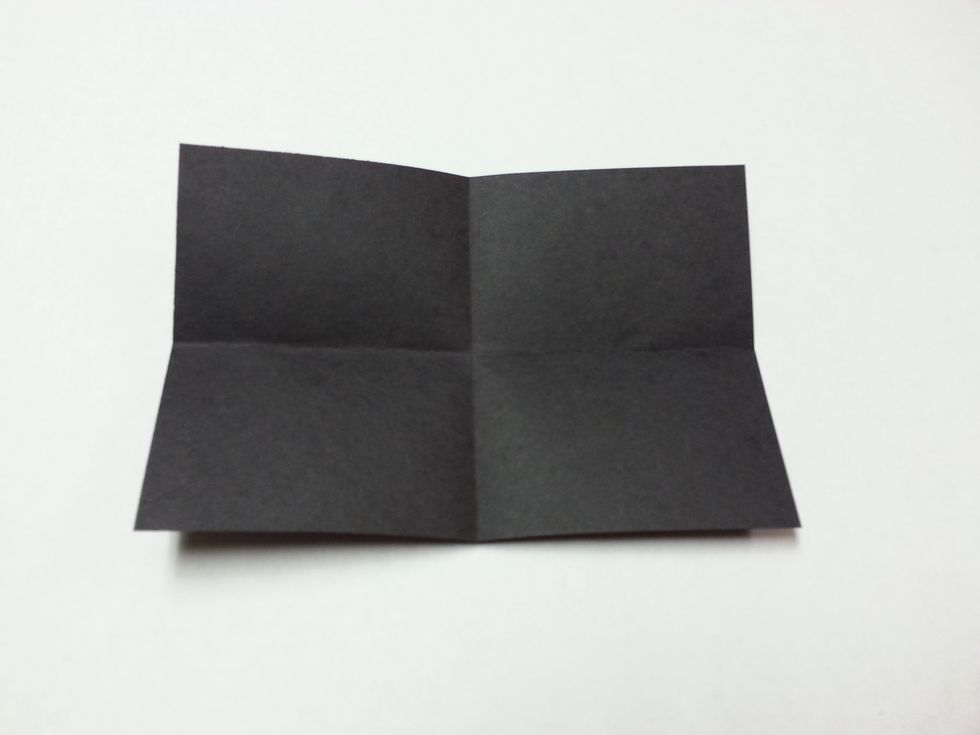 Fold the black rectangle into fourths. (Fold in half, and then in half again. You should have 4 equal sections.)
