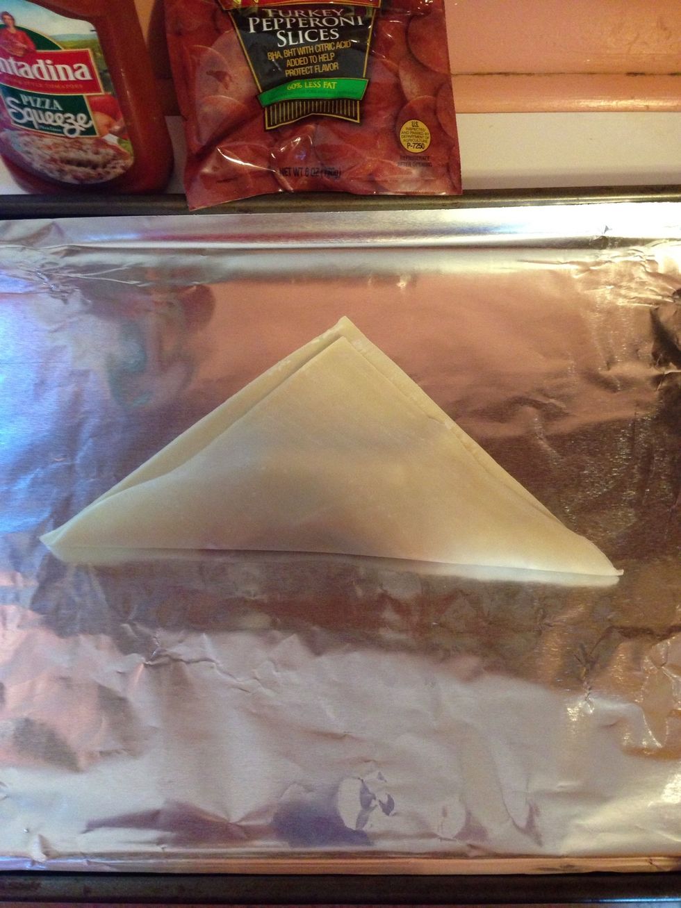 Fold the bottom corner closet to you up over the ingredients.