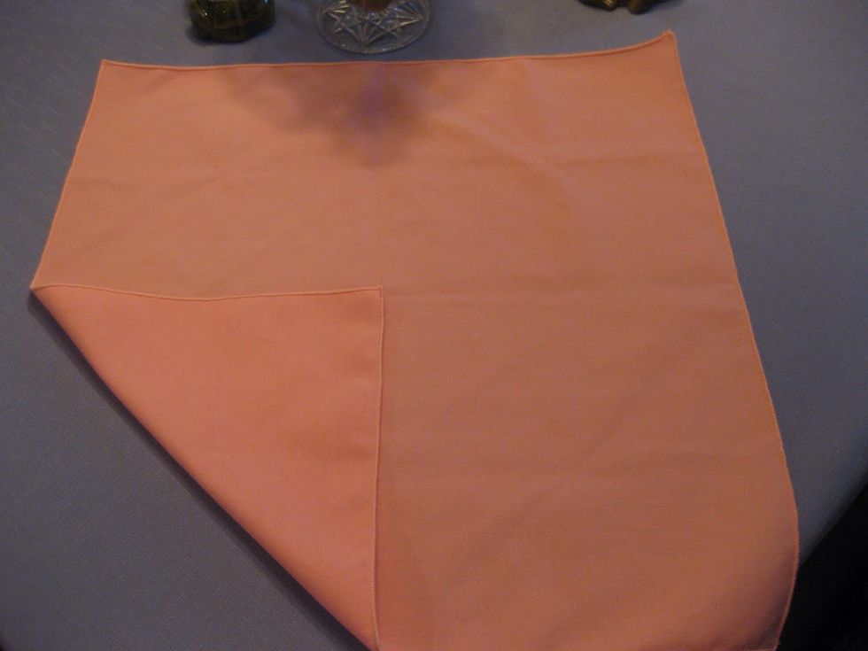 Fold the bottom corner to the center of the napkin