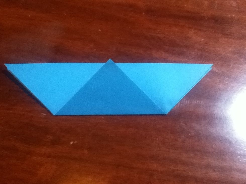 Fold the bottom corner to the top edge using the vertical crease as a guide