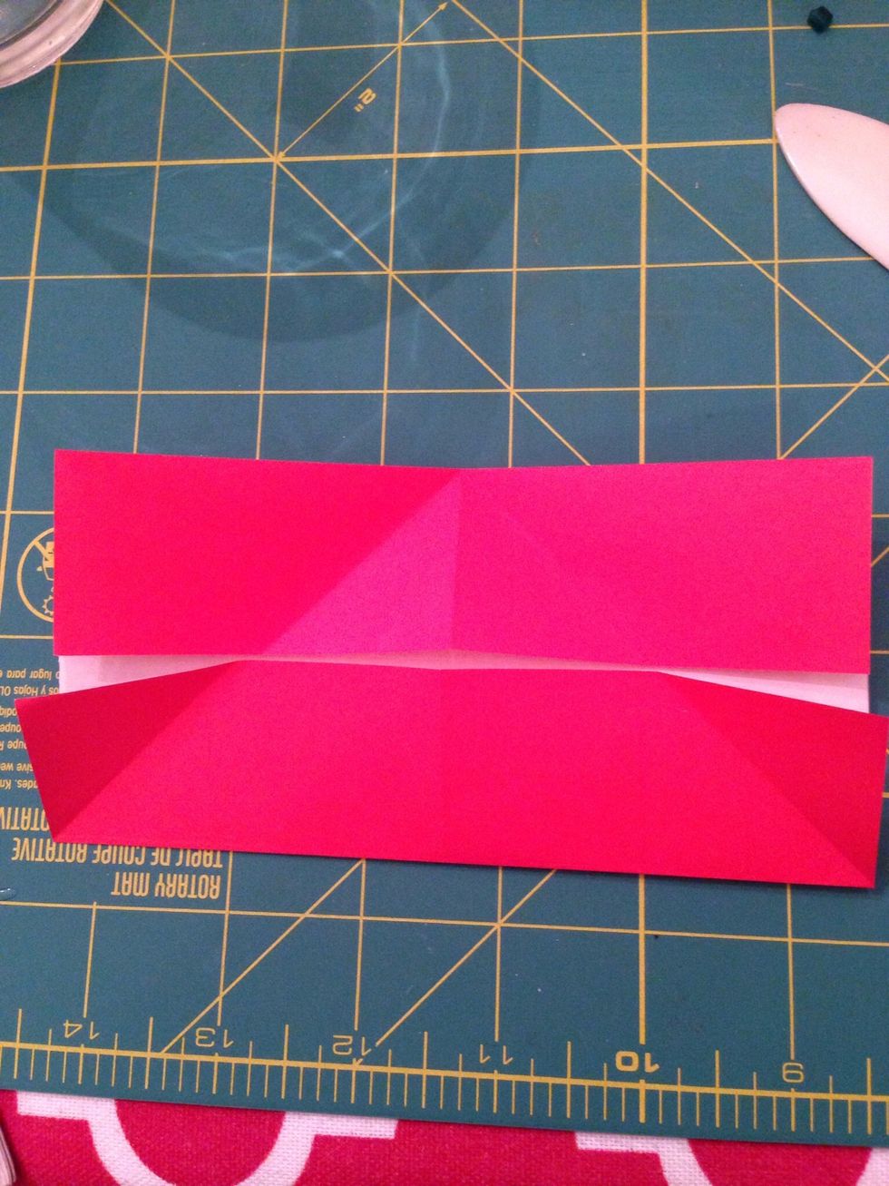 Fold the bottom corners to the center crease in the same way. Unfold.