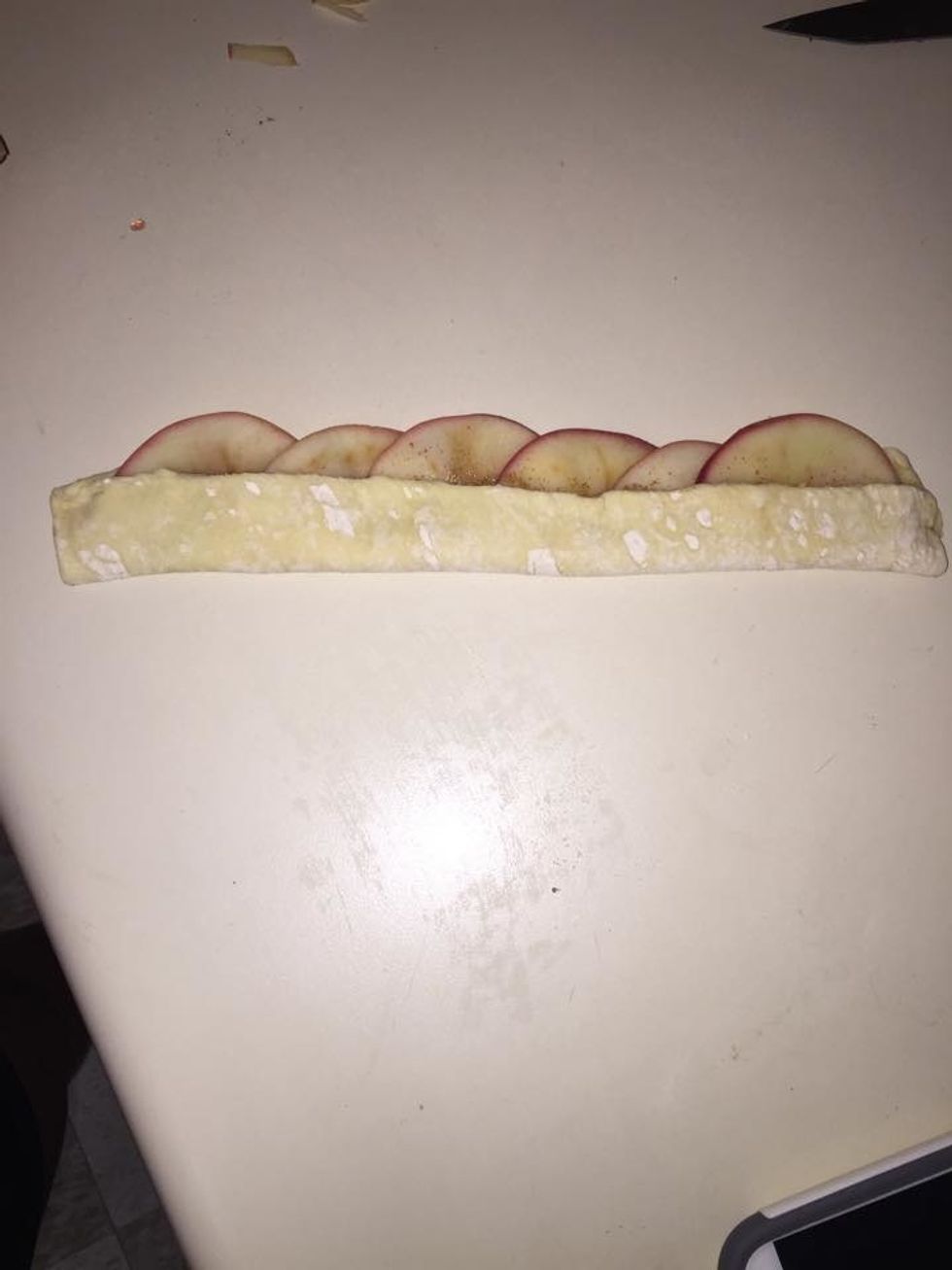 Fold the bottom edge of the strip on the apples.