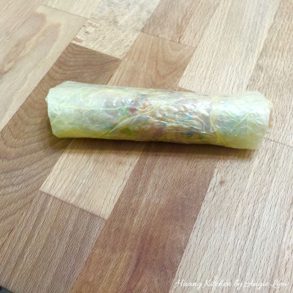 Fold the bottom flap up and then fold the sides over the meat filling. Then roll over tightly to form a meat roll.