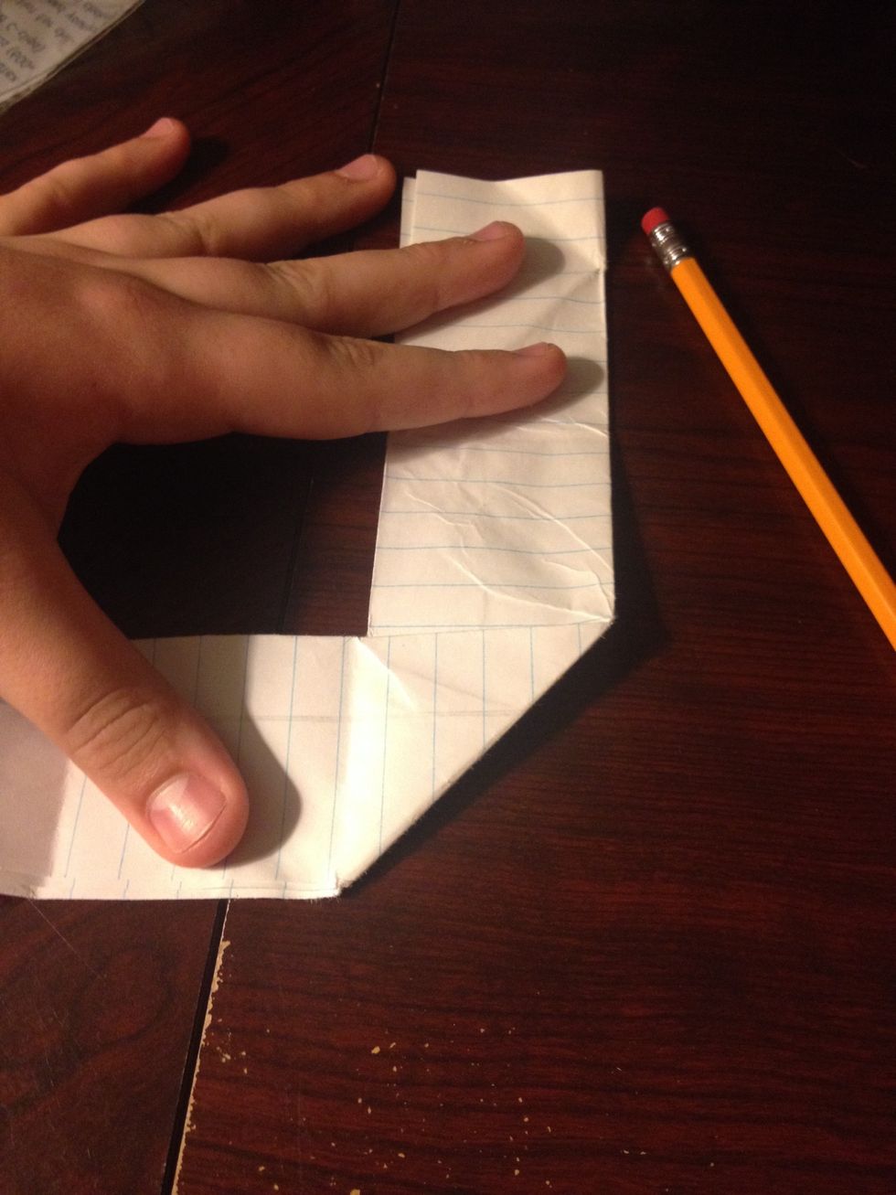 Fold the bottom half off to the side at the crease to create a backwards L shape