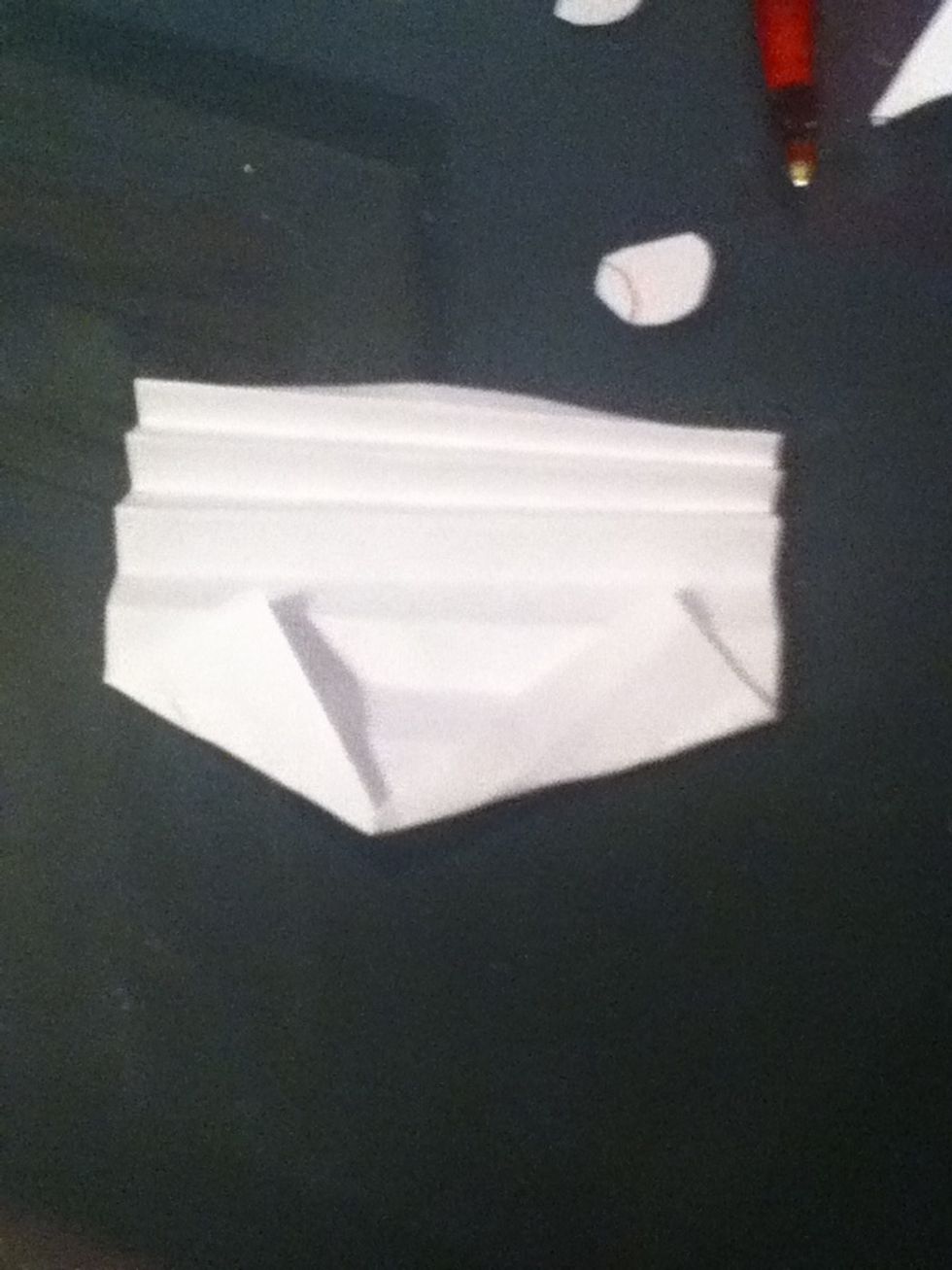 Fold the bottom (or top) till you get a point.