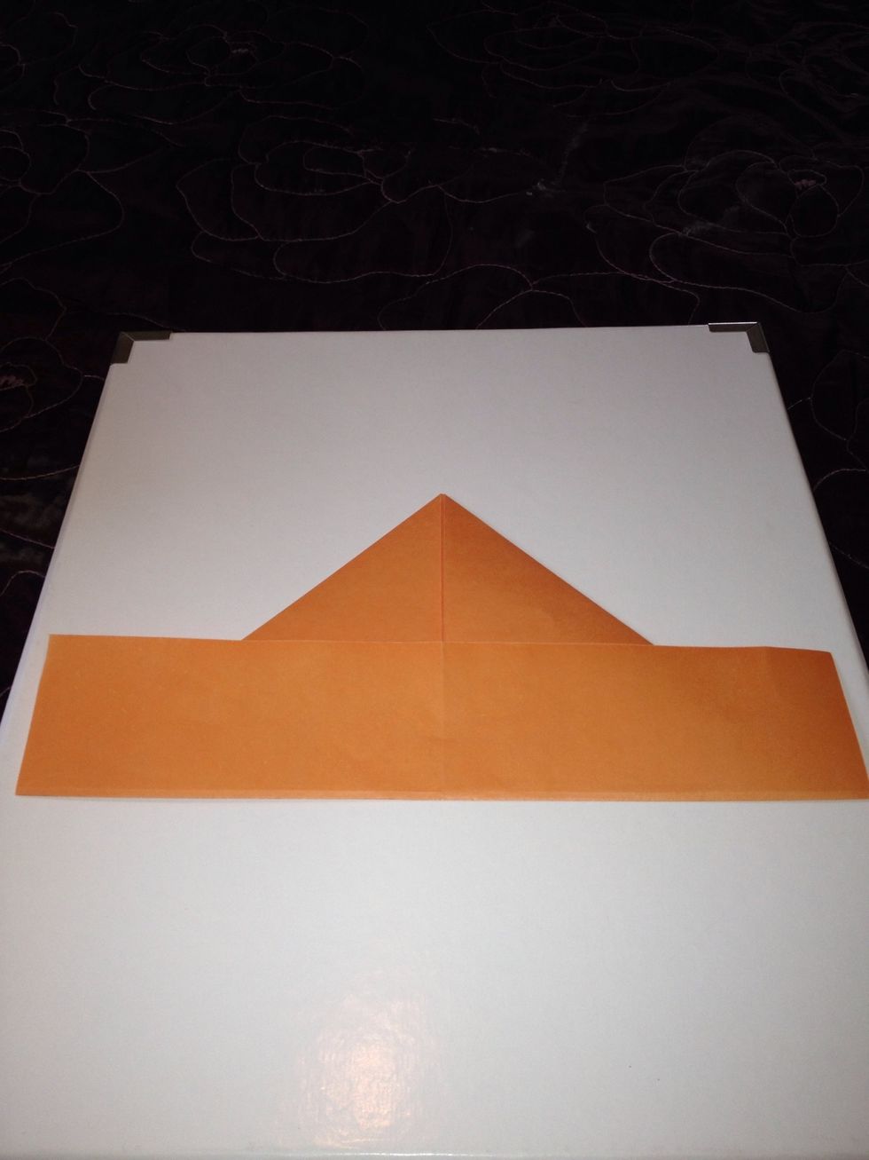 Fold the bottom up so that you have a triangle and a long bit. Remove the long bit so you end up with a triangle.