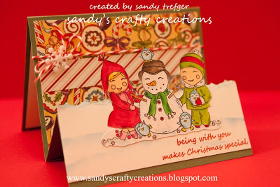 Fold the card up. Add a piece of red & white Baker's twine and tie in a small bow on the left side and top with a button or snowflake. Visit my Blog: http://www.sandyscraftycreations.blogspot.com