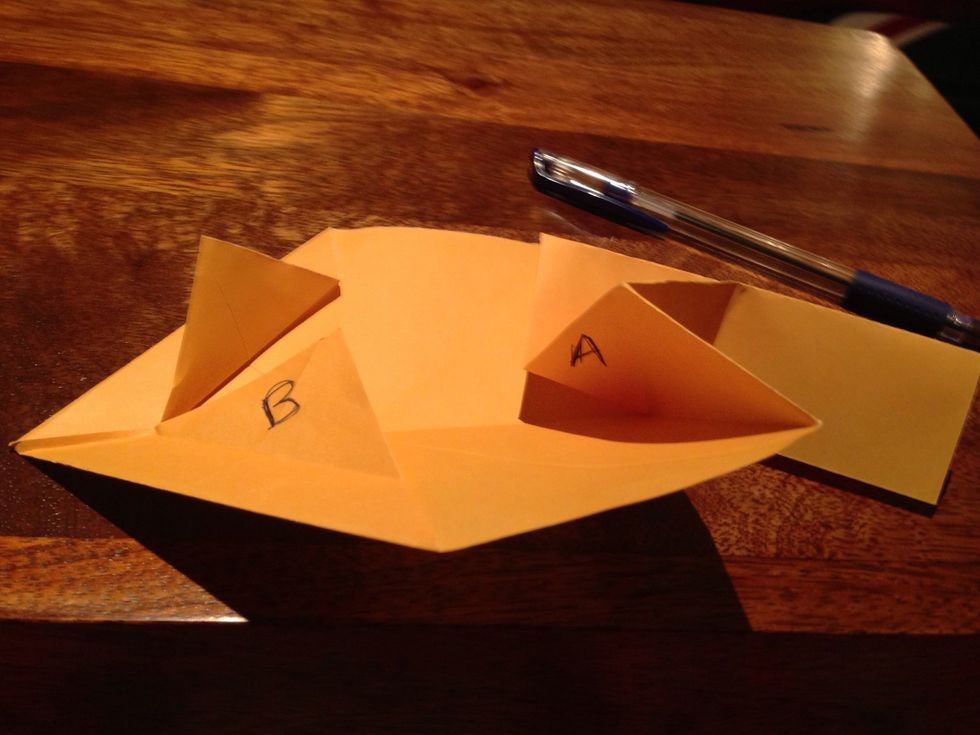 Fold the centre so that 2 flaps of point B come together.