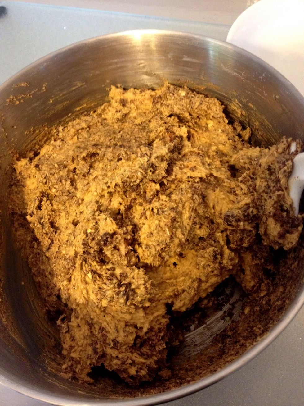 Fold the chocolate chips, grated chocolate and nuts into the cookie batter.
