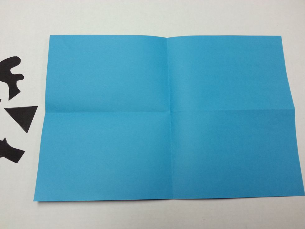 Fold the colored paper into fourths. (Fold in half, and then in half again. You should have four equal sections.)