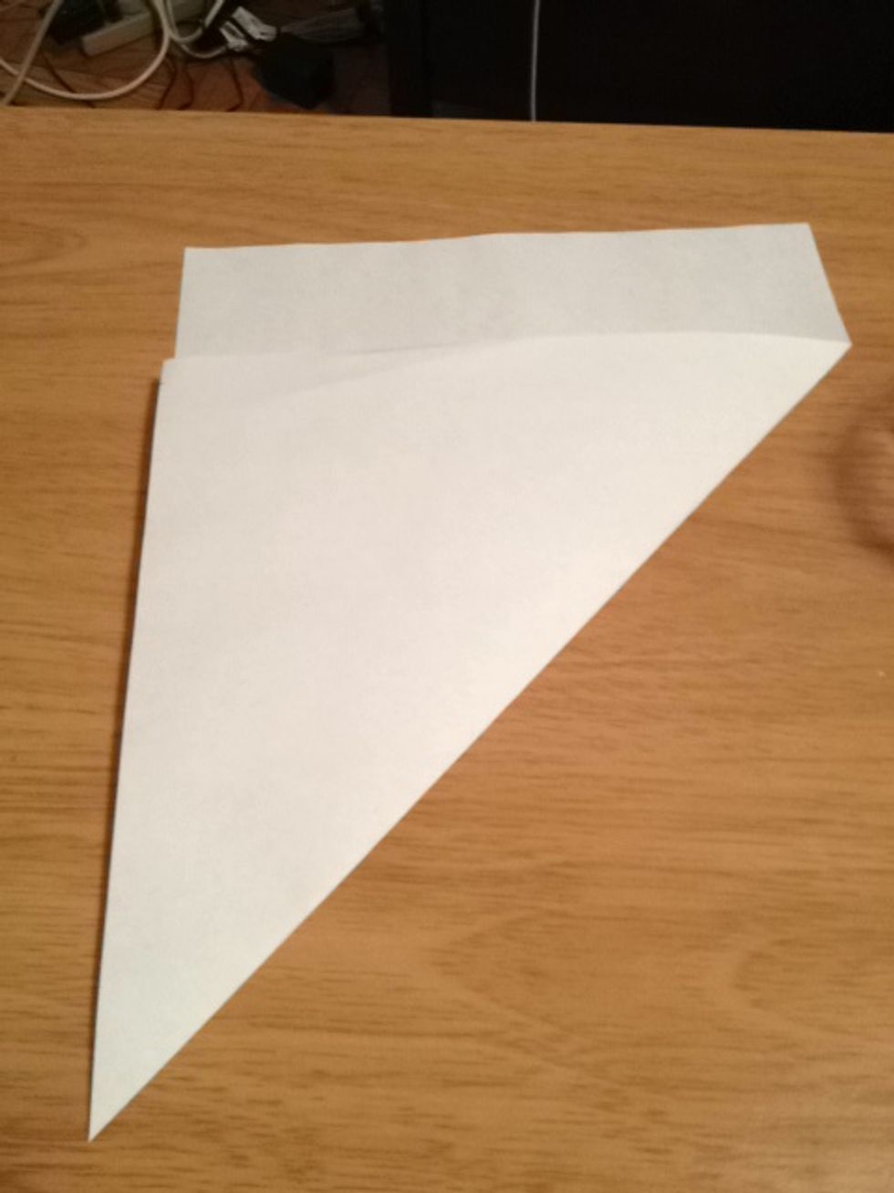 Fold the corner all the way across to line up with the opposite edge.