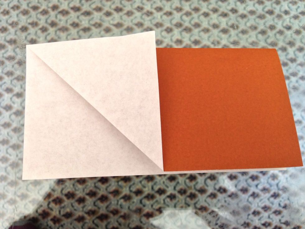 Fold the corner diagonally to the fold at the top. Then fold the top left corner in an opposing diagonal. See the result in the next photo.