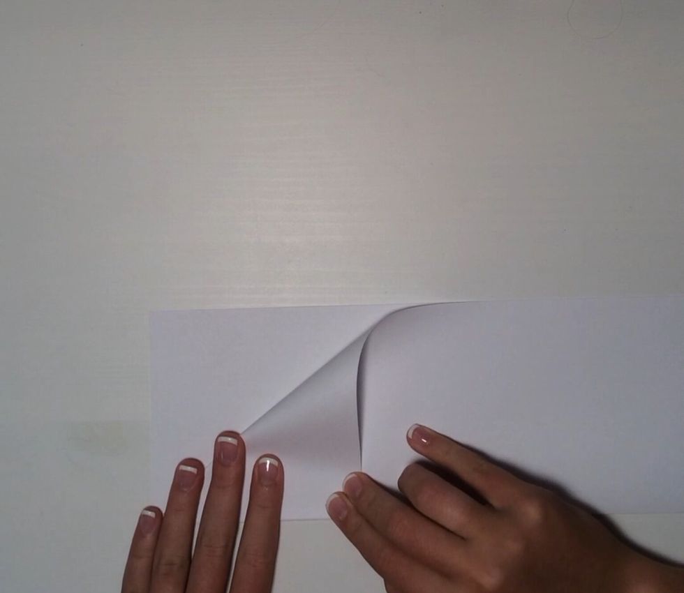 Fold the corner down towards the previous fold.