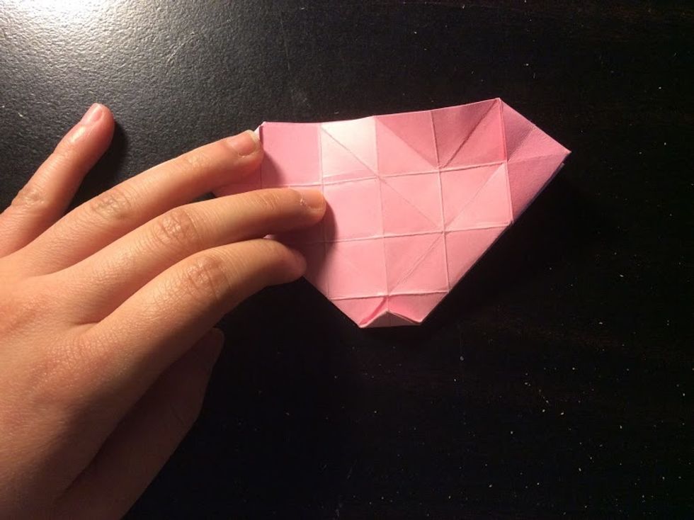 Fold the corner of the paper, then unfold it.