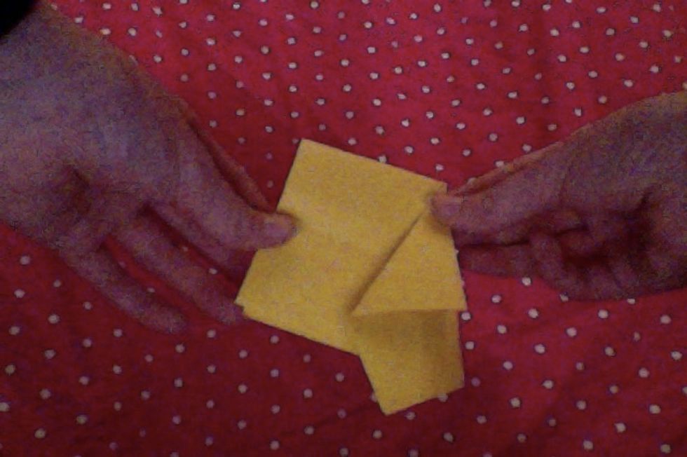 Fold the corner's tip back the other way.
