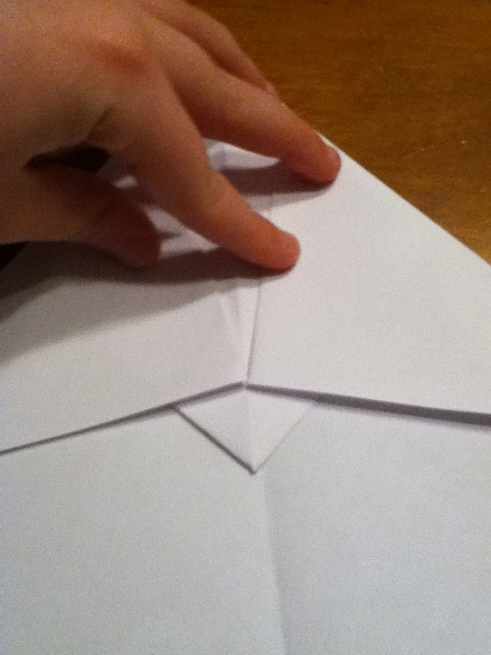 Fold the corners down so you will have a 1 inch triangle sticking out.