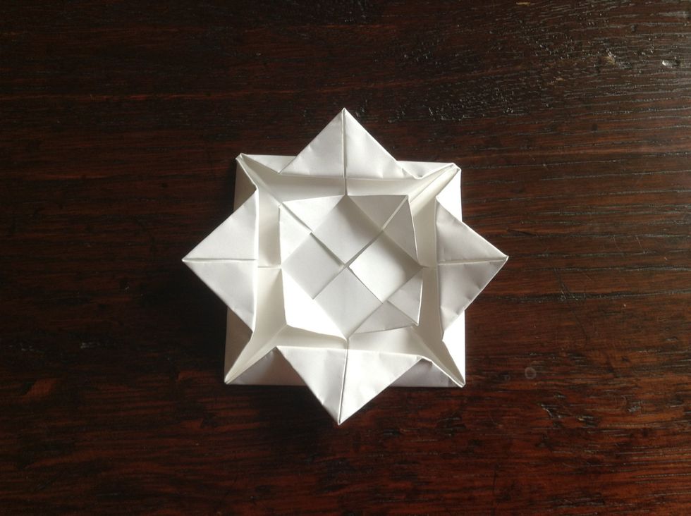 Fold the corners in the middle out to make the next layer of petals.