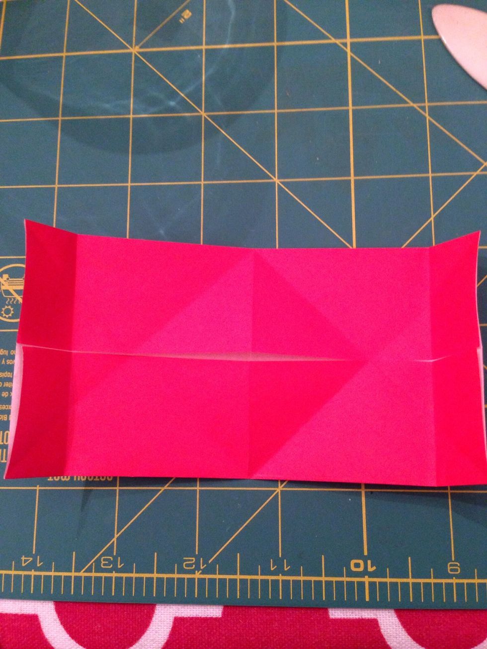 Fold the corners inward to the side creases.