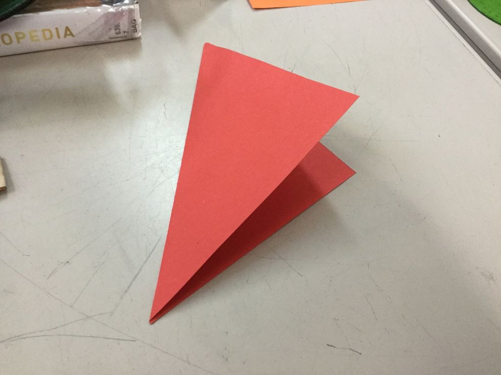 Fold the corners together diagonally to make the first fold