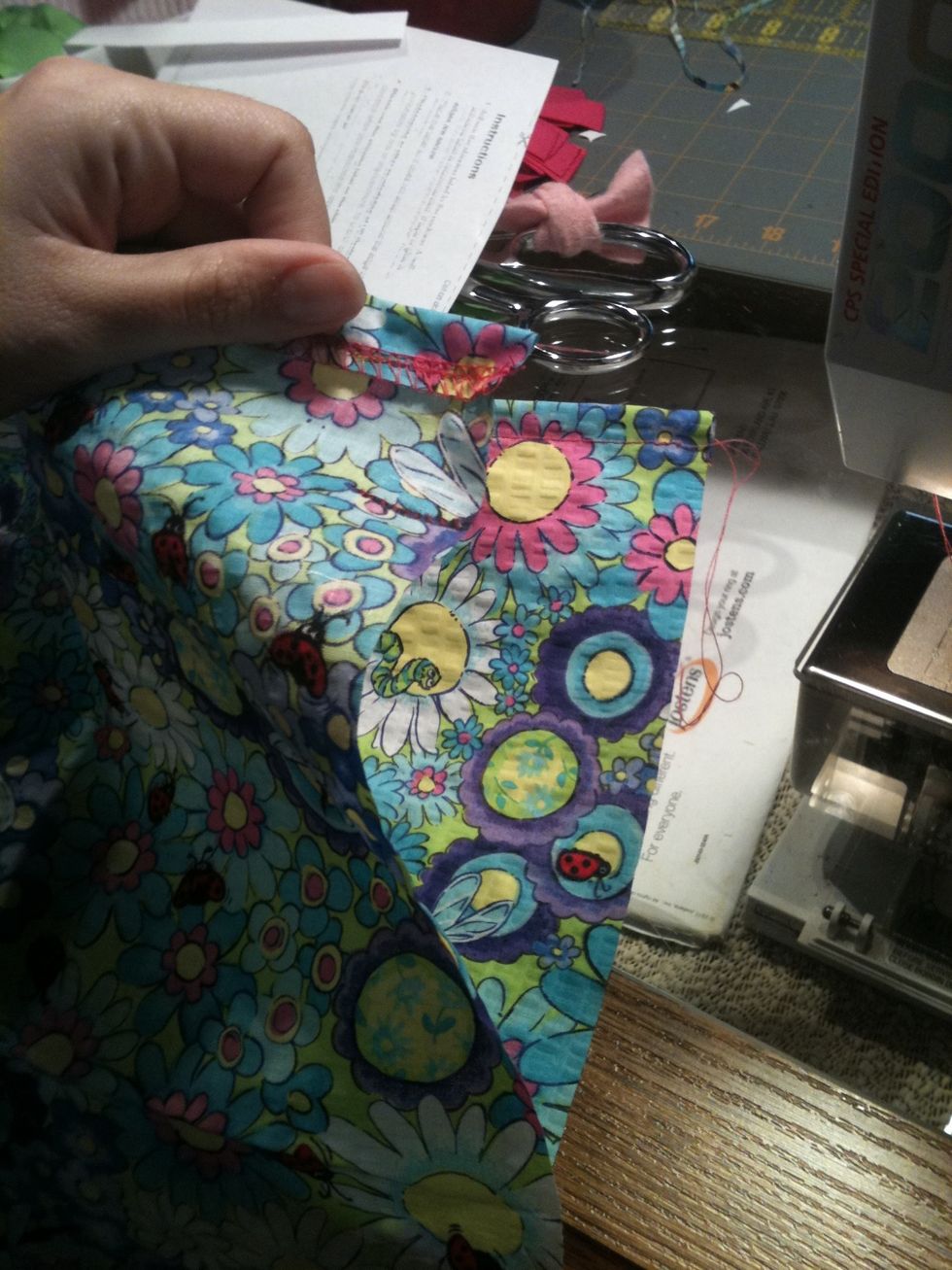 Fold the dress in half, right sides together. The bottom hem needs to match up, it isn't as important at the top.