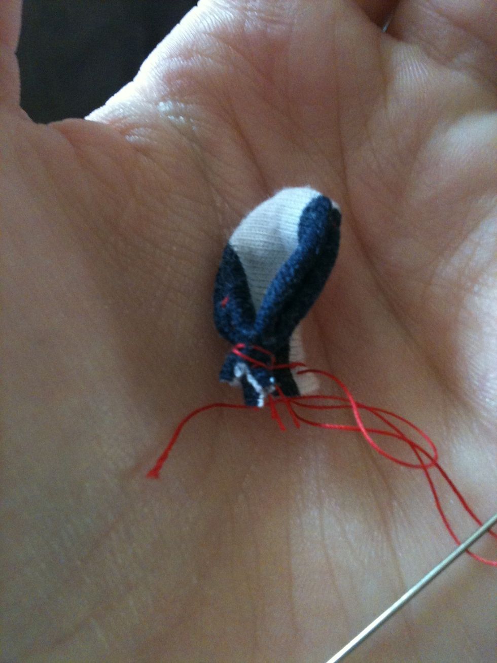 Fold the ear in half and sew along the bottom of it to keep it in shape. Sewing the ear to the head is pretty tricky so be warned...