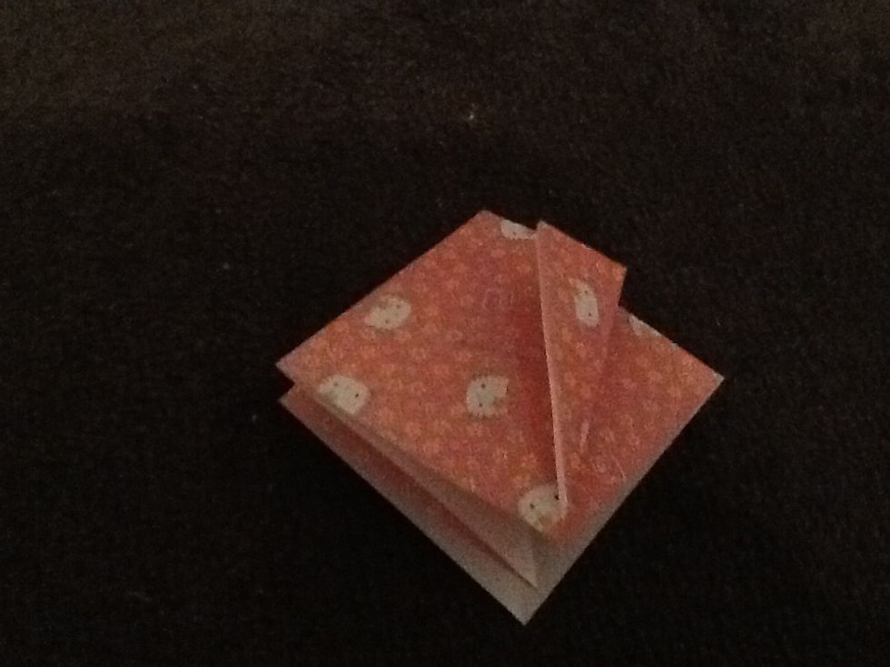 Fold the edges into the middle make sure the opening is at the bottom at the kite shape