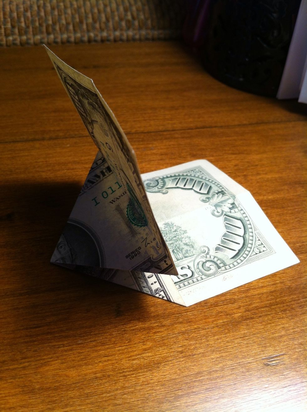 fold the end of the bill up over the triangular center section keeping the crease as close to the triangle as possible.