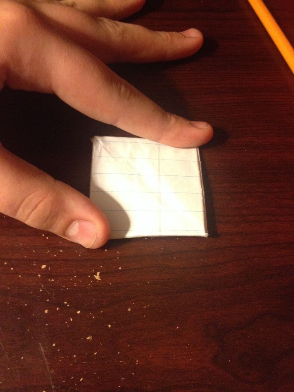 Fold the extra piece of paper behind the square