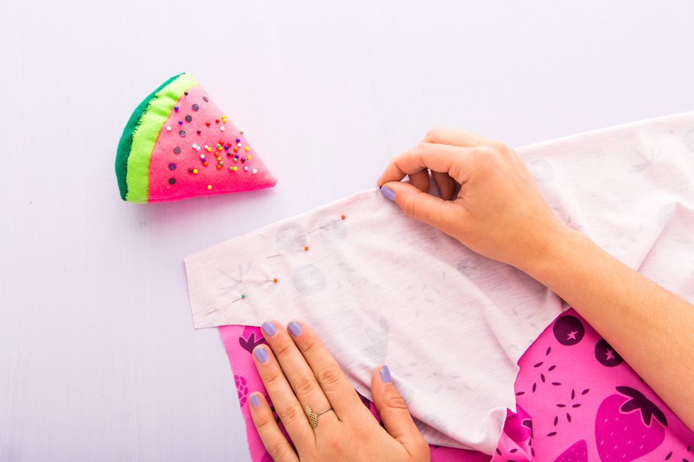 Fold the fabric on the chalk line and pin a diagonal line, creating a triangle with the point facing inward.