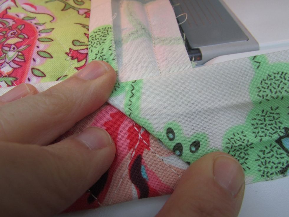 Fold the fabric trim to the right so that it forms a triangle edge.