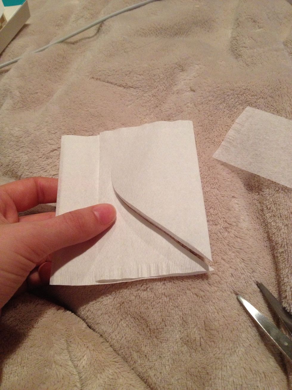 Fold the filter in half and cut out your heart shape. Try to cut the point where the seam is to keep both sheets together while you work...