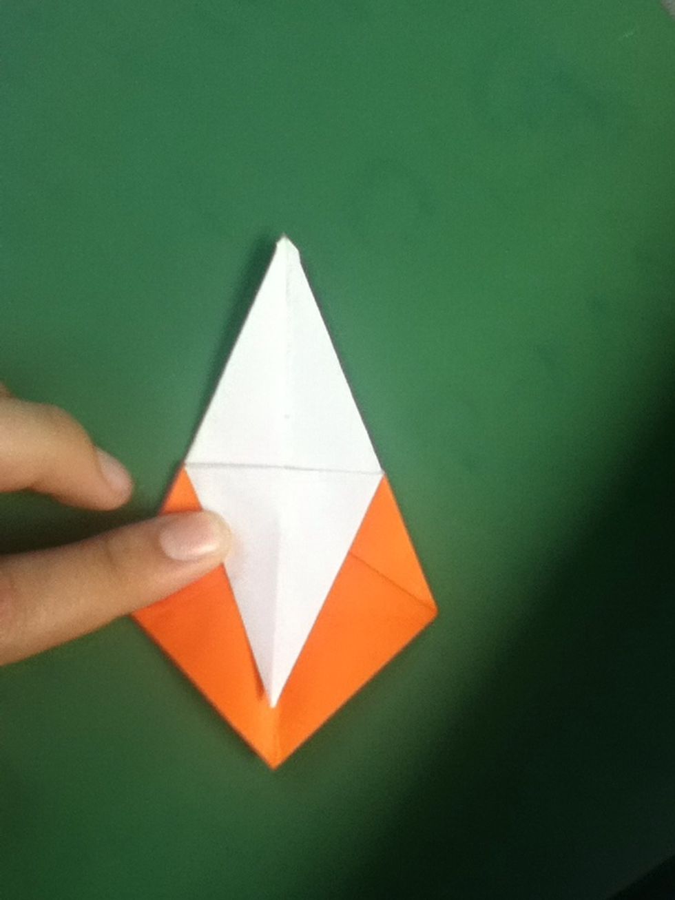 Fold the flap on the right across to the left; fold the topmost layer of the upper flap down as far as it will go