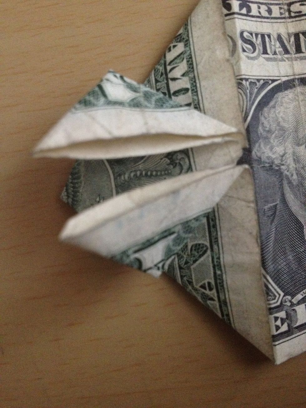 Fold the flaps upwards like so (do on BOTH halves of dollar).
