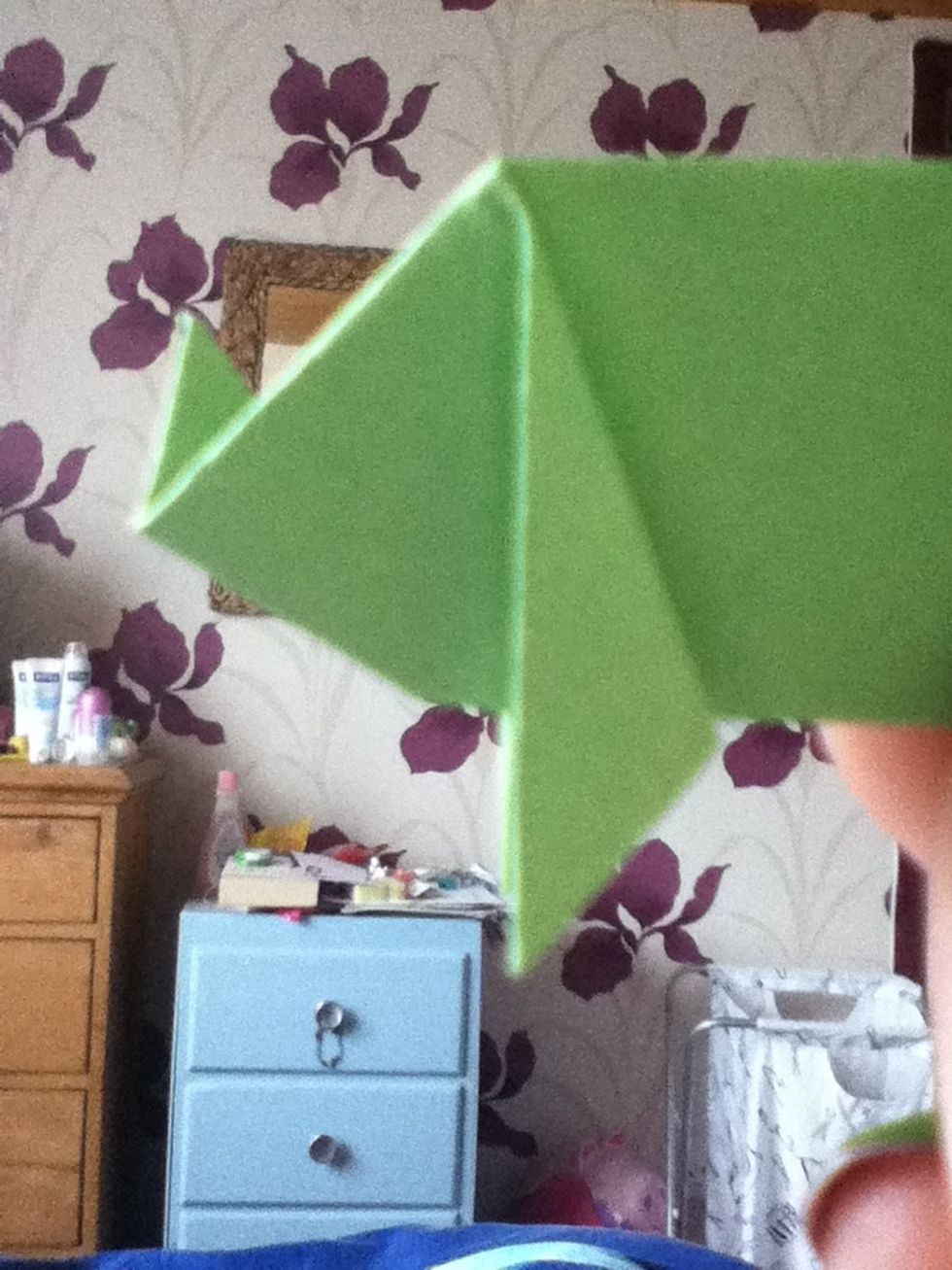 Fold the front corner upwards, to make the nose.